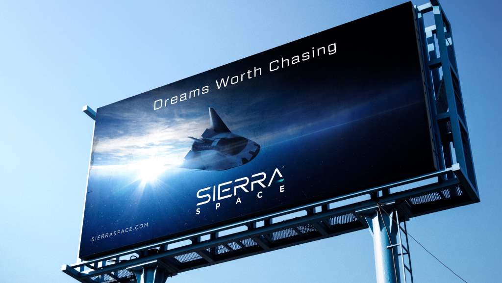 Sierra Space billboard featuring the 'Dreams Worth Chasing' rebranding campaign