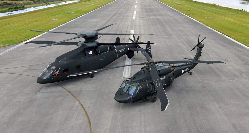 A Defiant X demonstrator (left) next to its predecessor Black Hawk Helicopter